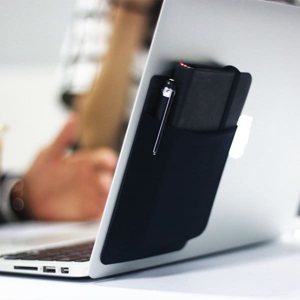 A portable external hard drive pocket holder in black, attached to a laptop, storing a hard drive and a pen. Portable External Hard Drive Pocket Holder - Image 1