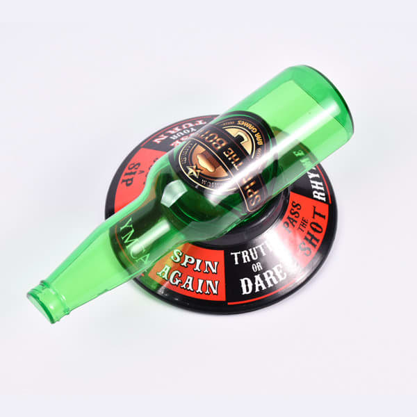A green drink bottle placed on a round black and red spinner with various prompts and a logo. Spin The Bottle - Image 1