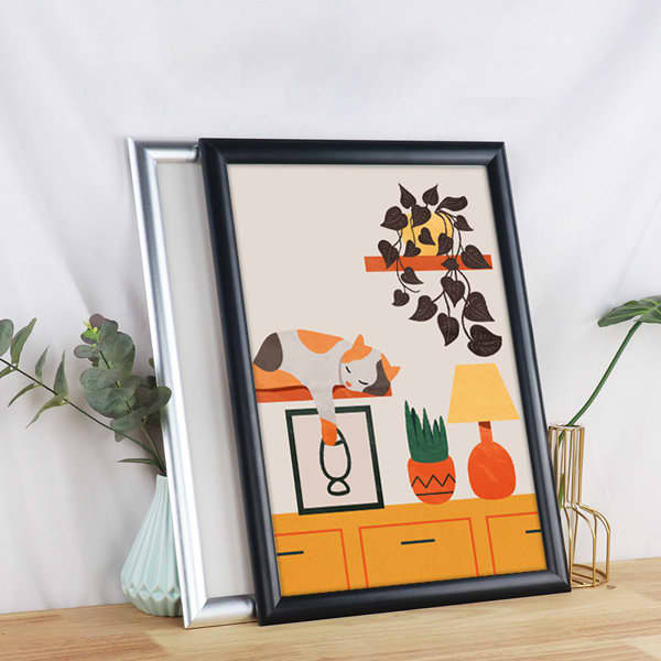 A black and silver front loading aluminium snap poster frame displays an illustrated scene with a cat, plants, and a lamp. Front Loading Aluminum Snap Poster Frames - Image 1