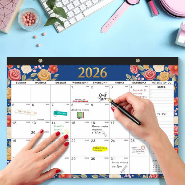 A monthly planning pad for 2026 with floral designs in blue and cream, featuring a hand writing on it. 2025 Monthly Planning Pad - Image 1