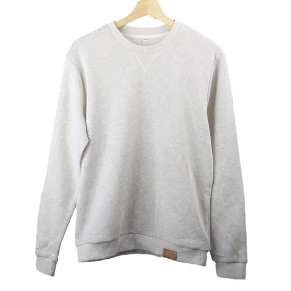 A light grey crew neck sweatshirt hanging on a wooden hanger, featuring a small logo on the hem. Comfortable Crew Neck Sweatshirt - Image 1