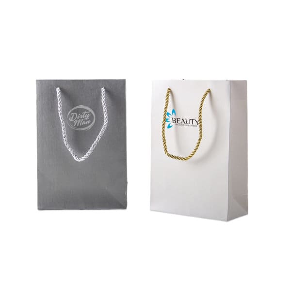 Two custom paper packaging bags, one grey with a logo and one white with a different logo, featuring rope handles. Custom Jewelry Paper Packaging Bag - Image 1