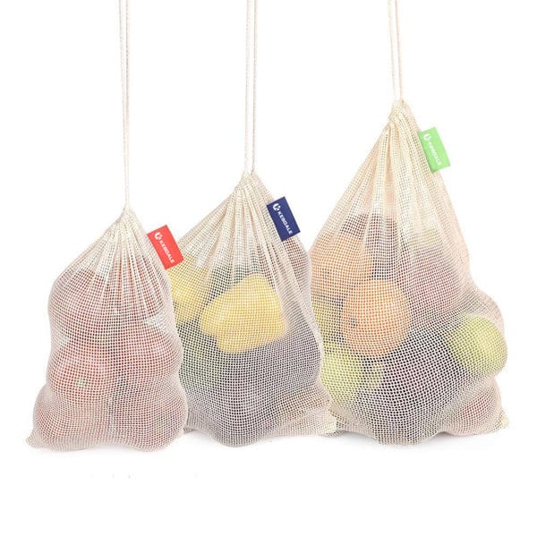 Three organic cotton mesh produce bags in cream, filled with various fruits, featuring coloured tags. Organic Cotton Mesh Produce Bag - Image 1