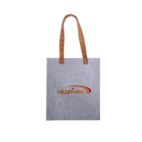 A grey felt tote bag with brown straps and a logo on the front. Custom Felt Tote Bag - Image 1