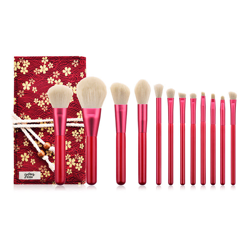 A 12-piece makeup brush set with red handles, featuring various brush shapes, displayed in a decorative box. 12 Pcs Makeup Brush Set - Image 1