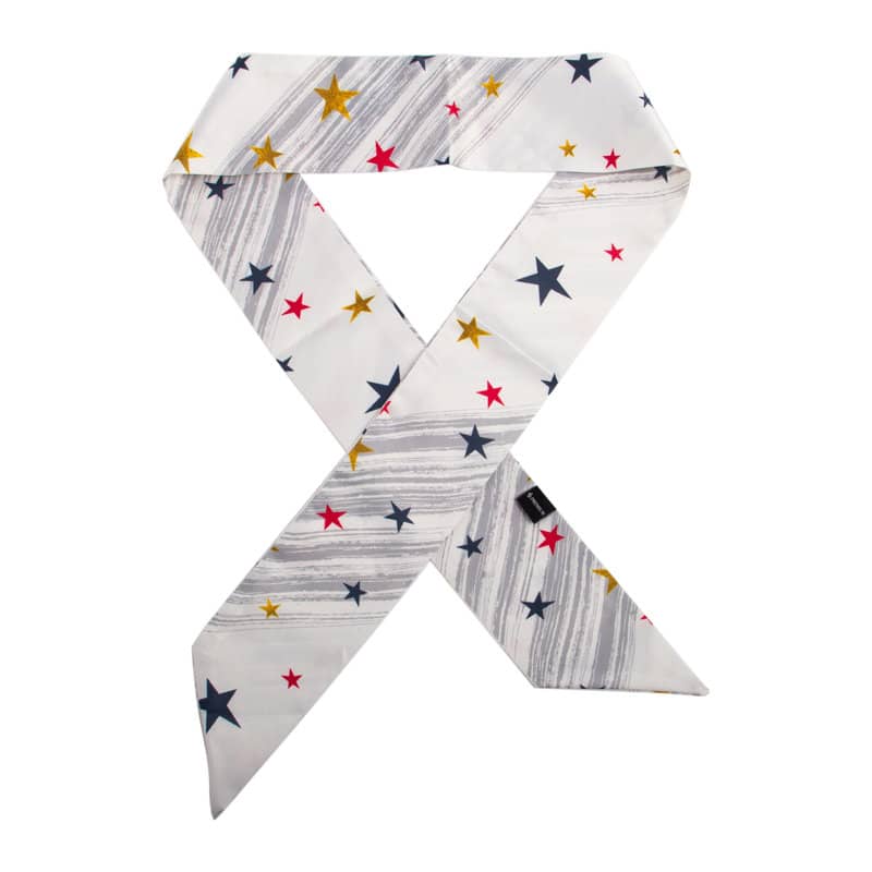 A custom skinny hair scarf featuring a white background with colourful stars in red, yellow, and navy. Custom Skinny Hair Scarf - Image 1