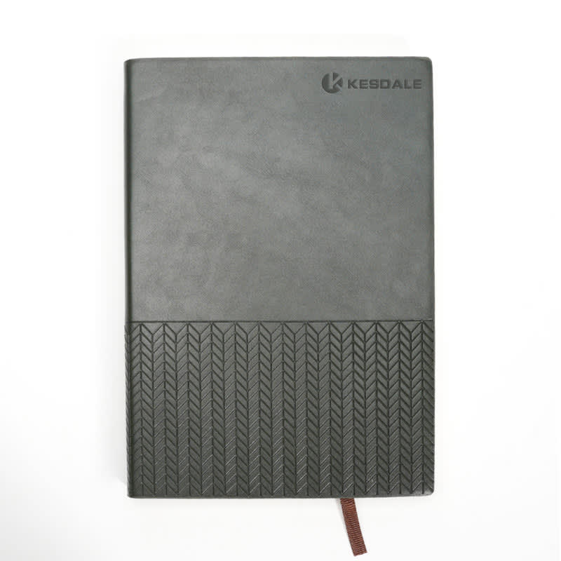 A grey lined notebook journal with a textured black bottom and a logo on the cover. Features a ribbon bookmark. Lined Notebook Journal - Image 1