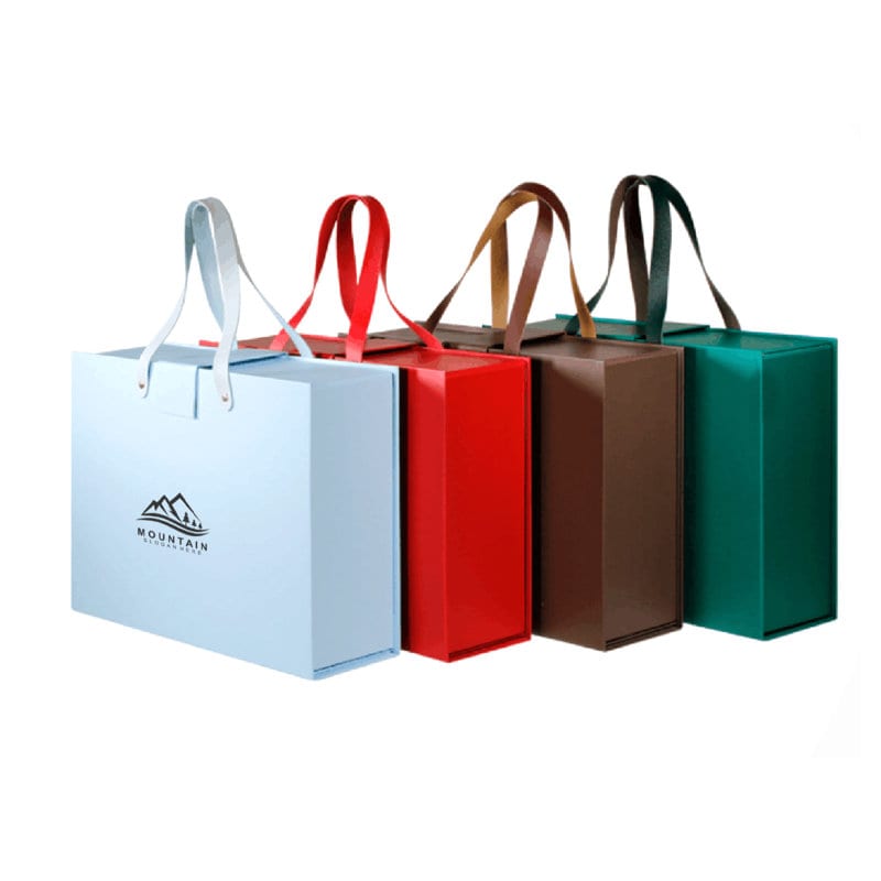 A set of four portable foldable gift boxes in blue, red, brown, and green, each with handles and a logo. Portable Foldable Gift Box With Handle - Image 1