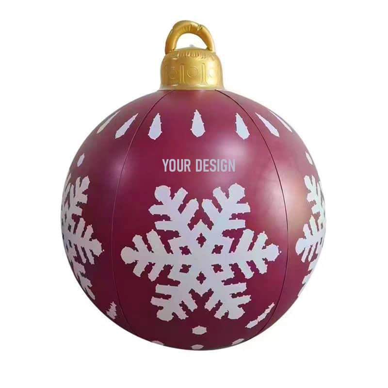 An inflatable Christmas ball in burgundy with white snowflakes and a gold hanging loop. Inflatable Decorated Christmas Ball - Image 1
