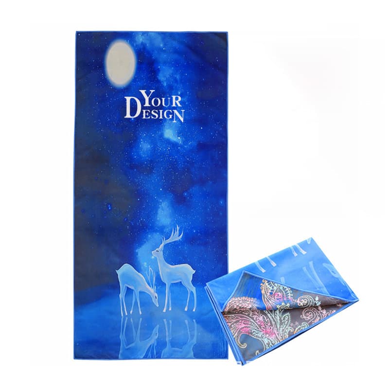 A custom microfiber beach towel featuring a blue design with a night sky and silhouette of deer, alongside a folded patterned towel. Custom Microfiber Beach Towel - Image 1