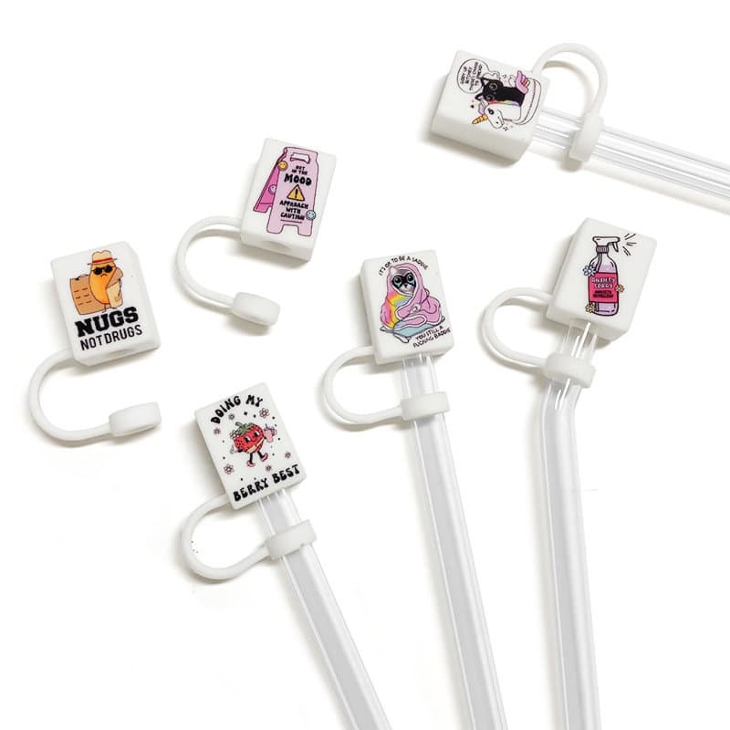 A set of custom silicone straw cover caps in various designs, featuring vibrant colours and playful graphics, with white straws. Custom Silicone Straw Cover Cap - Image 1